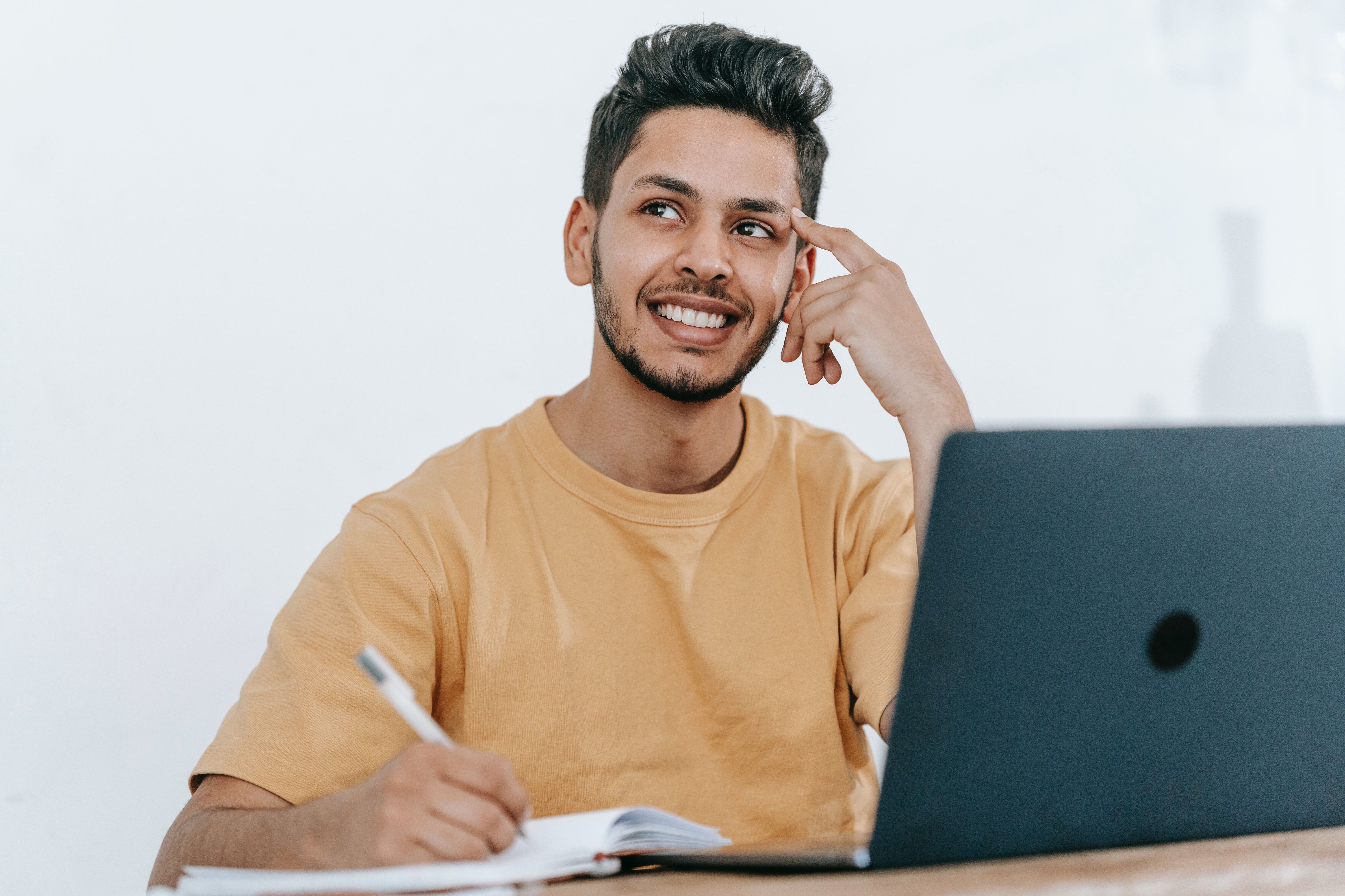 Man Writing on Laptop